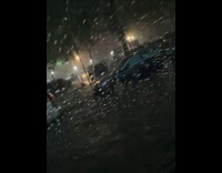 Filmer inside vehicle drive through flooded road