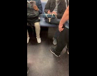 Guy on subway with earring of tiny goldfish in a plastic bag