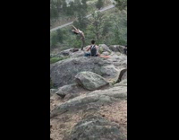 Girl grey top spin pole mountain cliff