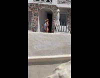 Woman white bikini poses for timer photoshoot