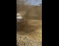 Truck plow through mud pool splash slow motion