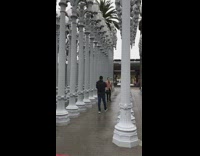 Brown jacket guy lamppost art installation rain