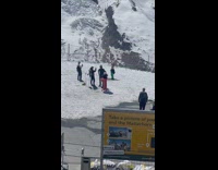 Girl green hat pants dance snow mountain