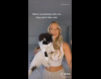 White shirt girl holds up different cats 