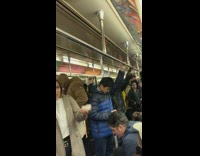 Guys sing and clap  We Will Rock You by Queen on subway train