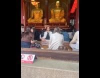 Woman meditates but faces phone instead Buddha