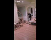 Dad roller skates around house with mop  