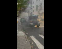 Burnt Car Gives Off Smoke in Street