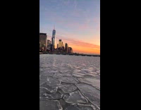 Pieces of ice float on river sunset