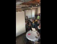 A bunch of people singing in a painting class