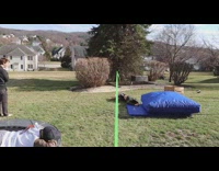 Guy jumps on slackline, trips and falls onto safety pad