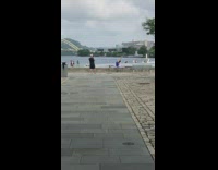 Woman blue top leg split on ledge