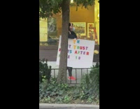 Woman with dont trust farts after mile 18 sign