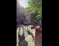 Man plays piano with two men plays boxing at the street 