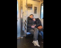 Couple falls asleep during a train ride
