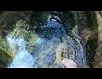 Guy swims inside deep river hole 
