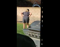 Woman and her dogs plays at the backyard under the sun