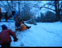 Woman sled with clownfish floaty and pops it