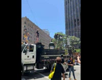 Woman in black shirt poses on top of the truck