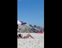 Women in colorful dress dances at the beach shore