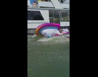 Guy jump from boat land on jet ski floaty