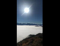 Person on mountain top sea of clouds