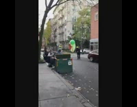 Two guys carry homemade grinch parade balloon 