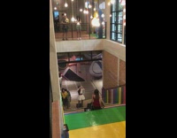 Girl in red dress sits on rainbow stairway 