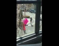 Girl pink jumpsuit hold many balloons street