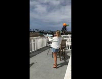Girl white sweater hold food caught rooftop