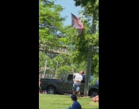 Man wave Corona logo Flag public park