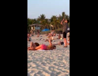 Man sings for beach video at sunset