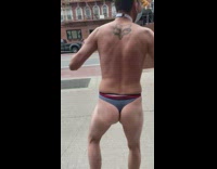 Guy wearing blue underwear dances with sign