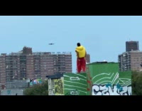 Man yellow vest dance on rooftop filmed by drone