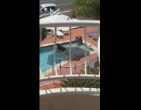 Guy lays on side poses pool platform  