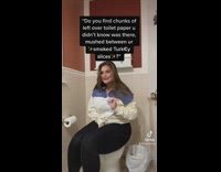 Woman pretends to pull out toilet paper between her legs 