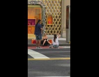 Black dress girl sits curb outside bvlgari 