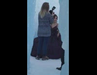 Woman takes picture in igloo