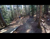 Guy rides bicycle behind friend who falls 