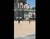 Guy throws dumbbell to the side beach 