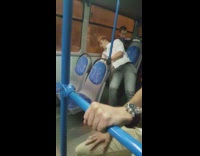 guy white shirt struggling to stand up on bus