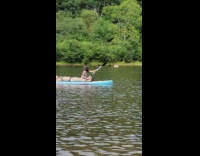 Mom lays on board while daughter paddles 