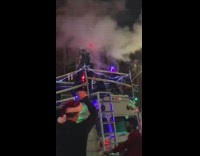 People dance in square on bus roof