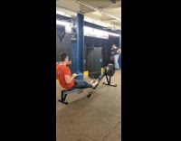 Man use rowing machine in subway station