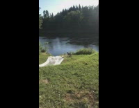 Bikini girl runs down grass hill falls 