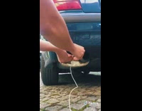 Guy puts white earphones in exhaust pipe 