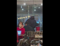 Guy in restaurant listening to music and dancing while clean windows 
