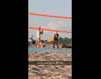 Black shirt girl beach sand volleyball net