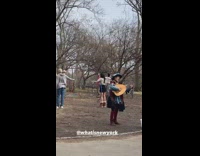 People hula hooping behind a trabadour performing