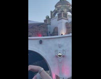 Woman in pink dress poses on the balcony at a concert